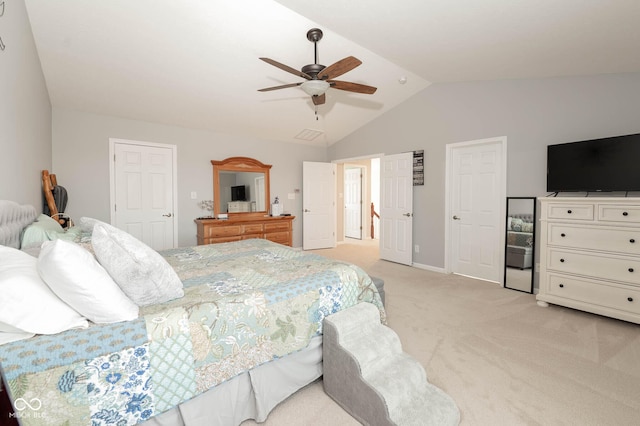 bedroom featuring baseboards, lofted ceiling, light colored carpet, and ceiling fan