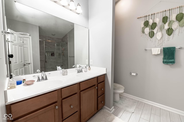 full bathroom featuring a shower stall, toilet, double vanity, and a sink