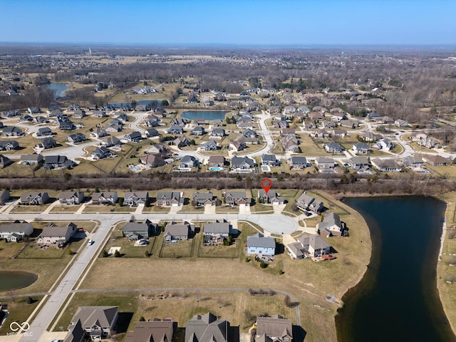 drone / aerial view featuring a residential view and a water view