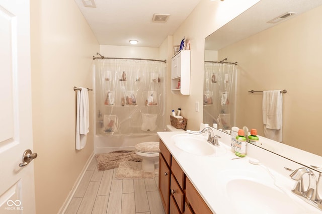 full bath featuring a shower with curtain, visible vents, and a sink