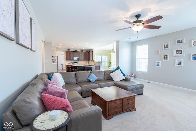 living area featuring recessed lighting, light colored carpet, baseboards, and ceiling fan