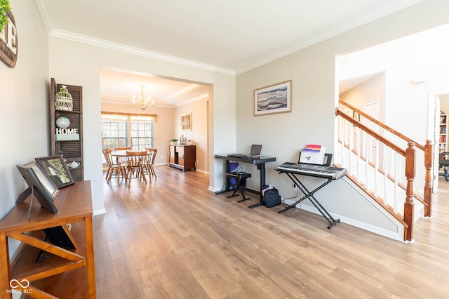 interior space with a notable chandelier, ornamental molding, stairs, and wood finished floors