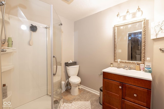 full bathroom featuring baseboards, vanity, toilet, and a shower stall