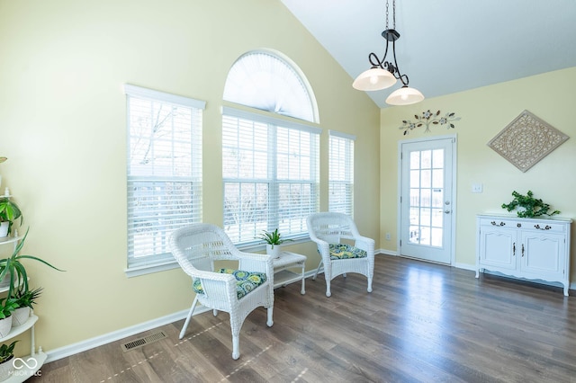 living area featuring baseboards, visible vents, dark wood-style flooring, and high vaulted ceiling