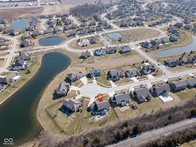 drone / aerial view featuring a residential view and a water view