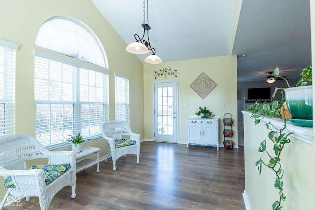 sitting room with ceiling fan, baseboards, high vaulted ceiling, and wood finished floors