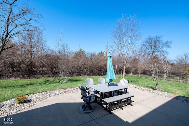 view of patio featuring outdoor dining area and fence