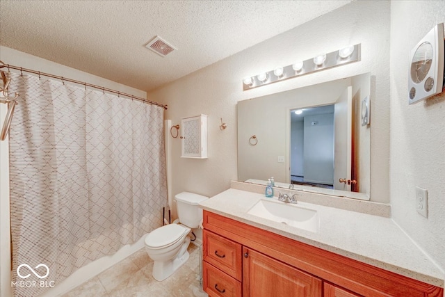 bathroom with tile patterned flooring, visible vents, toilet, vanity, and a textured ceiling