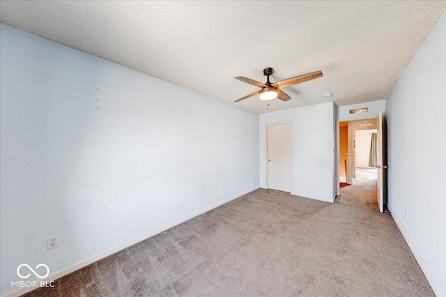 unfurnished bedroom featuring a textured ceiling, carpet, and a ceiling fan