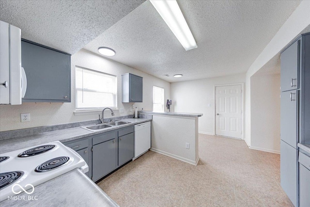 kitchen with a sink, a textured ceiling, white dishwasher, light countertops, and baseboards