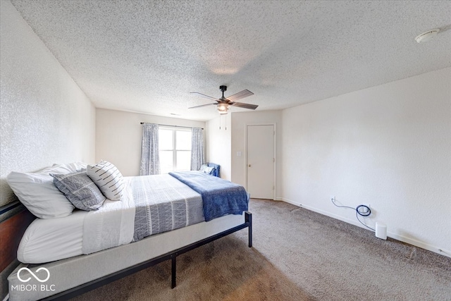 carpeted bedroom featuring a textured ceiling, baseboards, a ceiling fan, and a textured wall