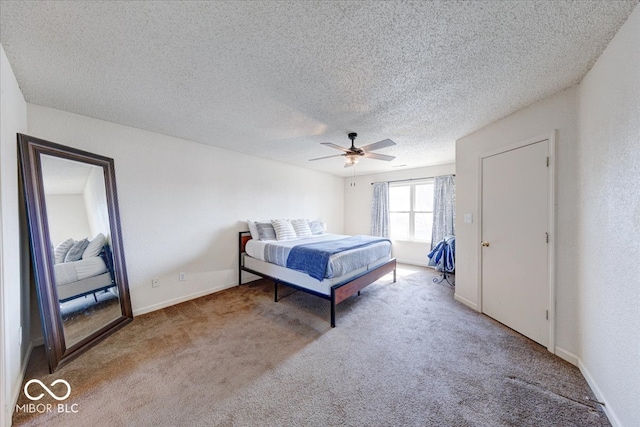 bedroom featuring baseboards, ceiling fan, a textured ceiling, carpet flooring, and a textured wall