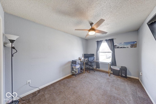 unfurnished office with a textured ceiling, baseboards, carpet, and a ceiling fan