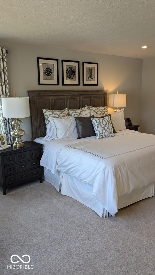 bedroom featuring carpet floors and a textured ceiling