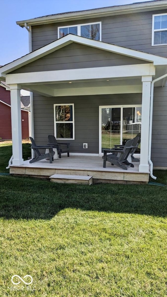 rear view of property featuring a lawn