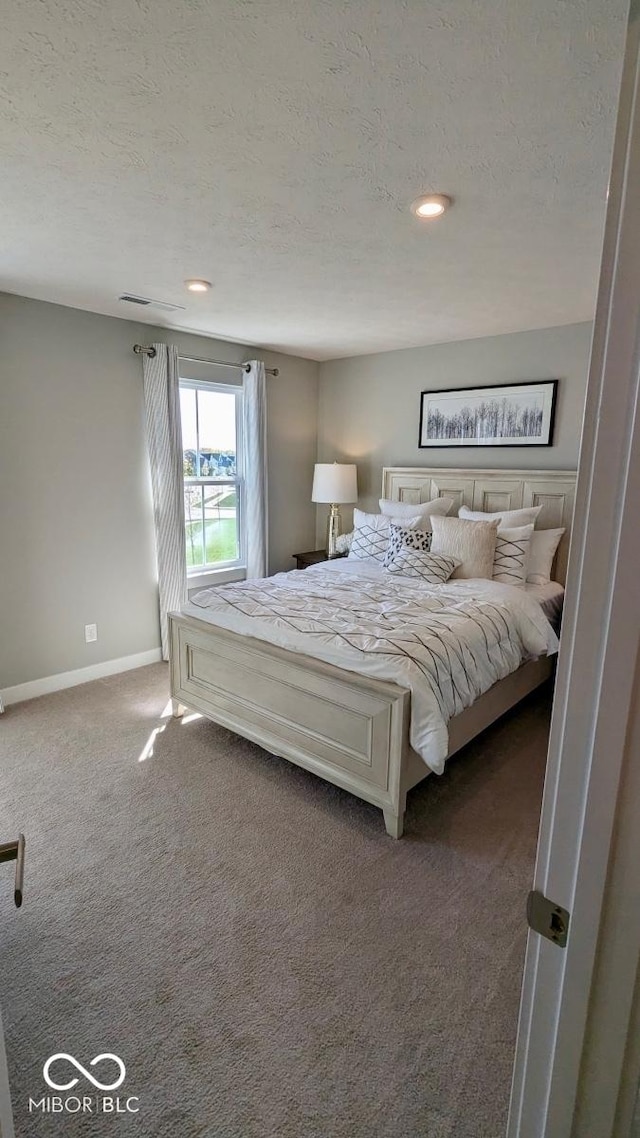 carpeted bedroom featuring recessed lighting, baseboards, and a textured ceiling