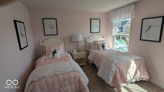 bedroom with baseboards and carpet floors