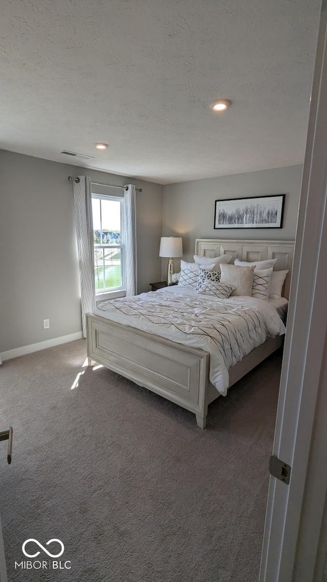 carpeted bedroom featuring recessed lighting, baseboards, and a textured ceiling