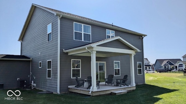 back of house with a yard and a wooden deck