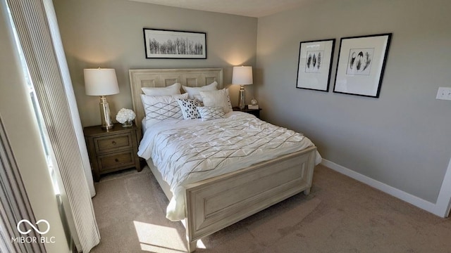 carpeted bedroom with baseboards