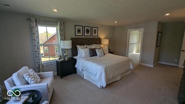 bedroom with light carpet, visible vents, recessed lighting, and baseboards