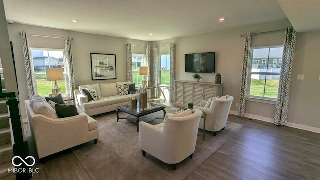 living area with recessed lighting, baseboards, and wood finished floors