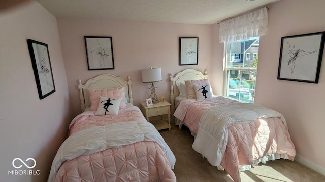 carpeted bedroom featuring baseboards