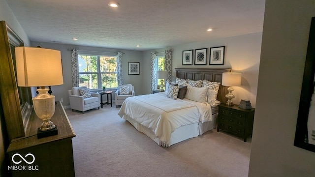 bedroom with recessed lighting, carpet floors, and a textured ceiling