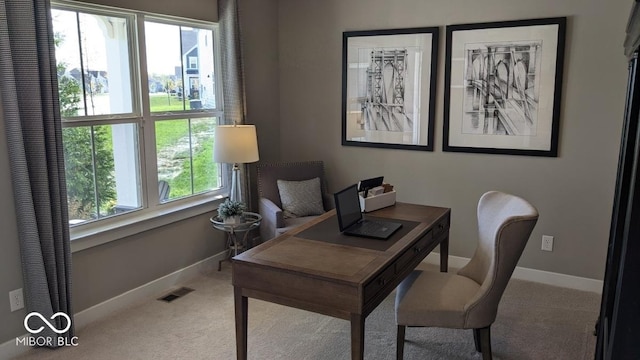 office space with carpet flooring, baseboards, and visible vents