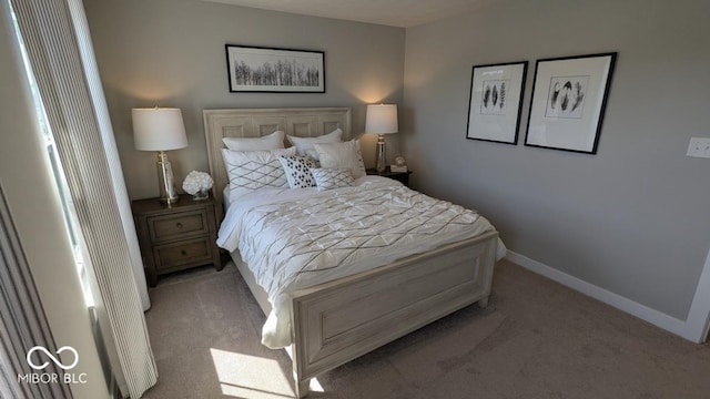 bedroom with baseboards and light carpet