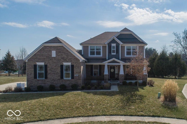 craftsman-style house with a front yard and brick siding