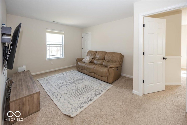 carpeted living area with visible vents and baseboards