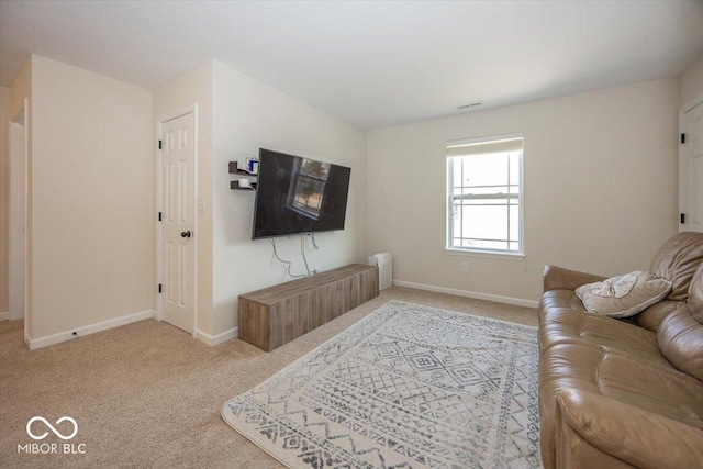 living area with light carpet, visible vents, and baseboards