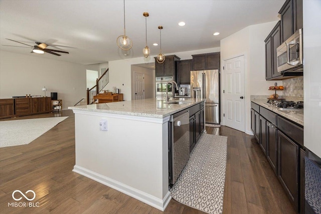 kitchen featuring a sink, a ceiling fan, dark wood-style flooring, and stainless steel appliances