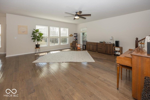 unfurnished room with wood finished floors, baseboards, and ceiling fan