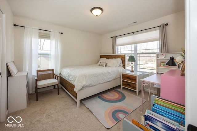 carpeted bedroom featuring multiple windows and visible vents