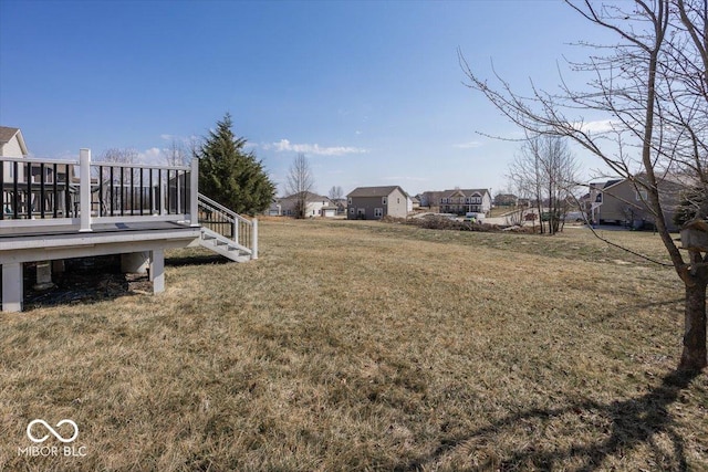 view of yard with a deck and a residential view