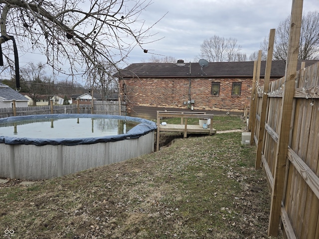 view of swimming pool featuring a fenced in pool, a lawn, and a fenced backyard