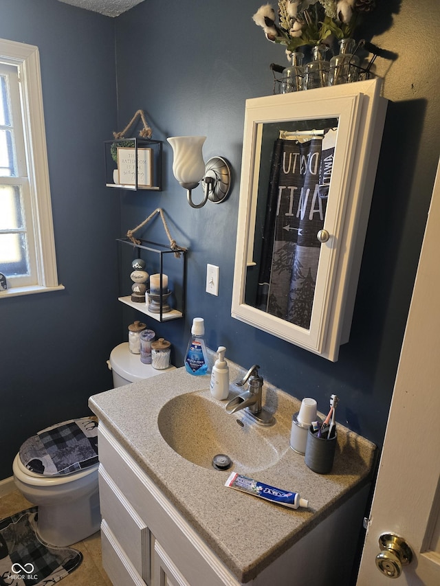 bathroom featuring tile patterned floors, toilet, and vanity