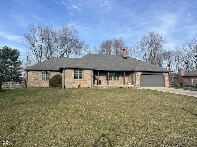 ranch-style home with roof with shingles, an attached garage, a chimney, concrete driveway, and a front lawn