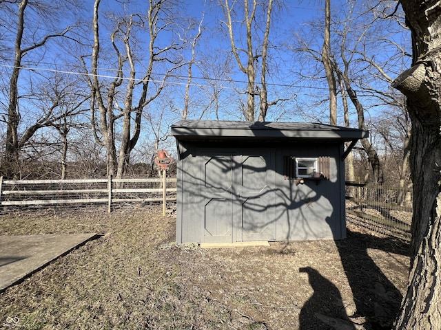 view of shed with fence