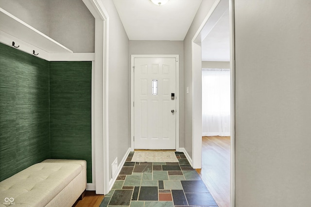 entryway featuring baseboards