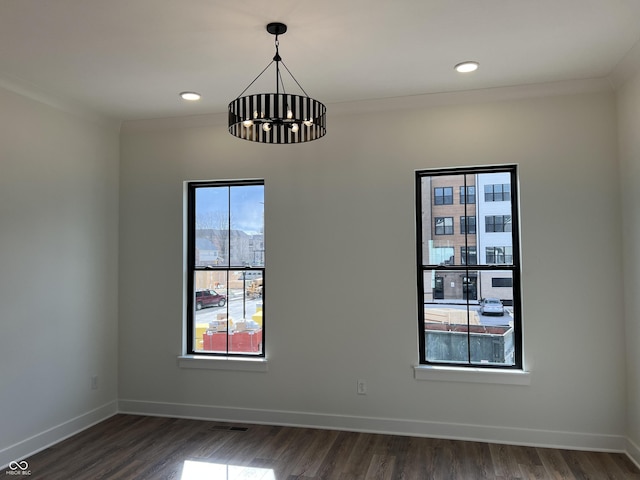 457 Mariposa Trl, Carmel, IN 46032 - spare room with a chandelier, baseboards, dark wood-style floors, and recessed lighting