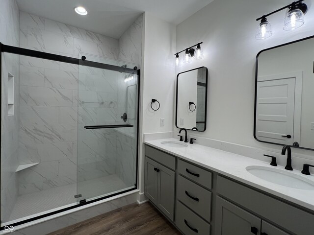 457 Mariposa Trl, Carmel, IN 46032 - full bath featuring wood finished floors, a marble finish shower, double vanity, and recessed lighting