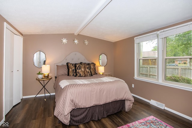 bedroom featuring visible vents, lofted ceiling with beams, baseboards, and wood finished floors