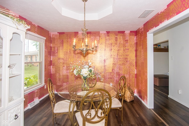 dining space with wood finished floors, baseboards, visible vents, wallpapered walls, and a chandelier