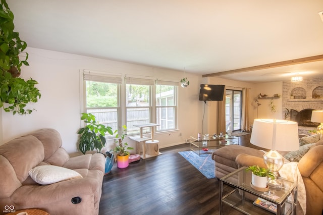 living room featuring beamed ceiling, baseboards, dark wood-type flooring, and a fireplace