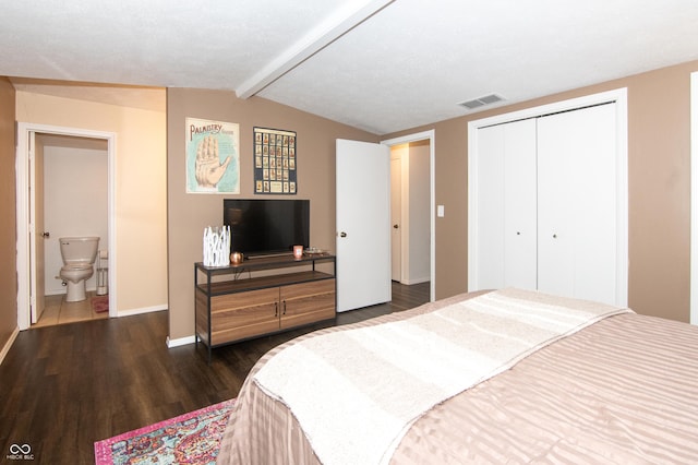 bedroom featuring baseboards, visible vents, vaulted ceiling with beams, dark wood-type flooring, and a closet