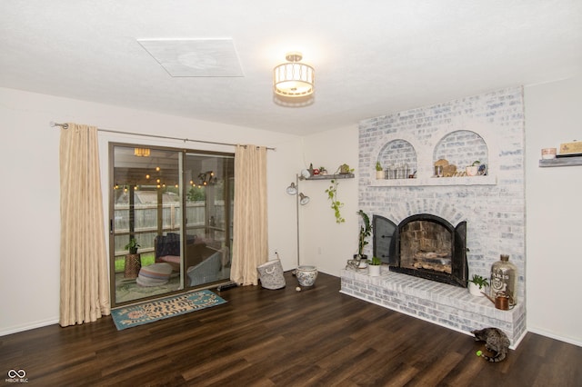 living room with a fireplace, wood finished floors, and baseboards