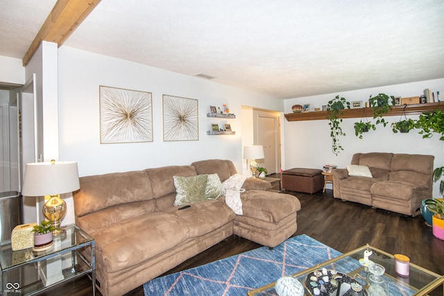 living room with visible vents, beamed ceiling, and wood finished floors